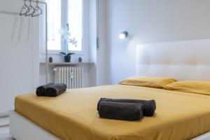 two black towels sitting on top of a bed at RELAX APARTMENT in the Mountains in Valdieri +1 photo