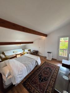 a large bedroom with a large bed and a rug at Villa Azkanean in Bidart