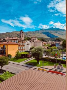a view of a city with a town with mountains at Hotel De Nac in Nago-Torbole