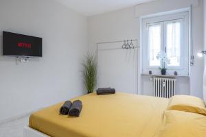 a bedroom with a bed with two slippers on it at RELAX APARTMENT in the Mountains in Valdieri