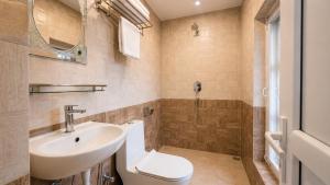 a bathroom with a sink and a toilet at Suva Garden Hotel in Kathmandu +25 photos
