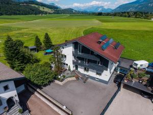 an overhead view of a large house with a red roof at Pension Ferienwohnung Pirhofer in Kramsach
