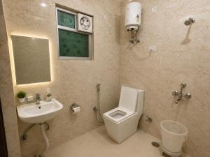 a bathroom with a white toilet and a sink at Hotel Bell Montana Stay Near IGI Airport Delhi- Free Airport Pickup & Drop in New Delhi +31 photos