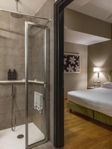 a glass shower in a bedroom with a bed at HOTEL ADRIANO Rooftop in Rome +130 photos