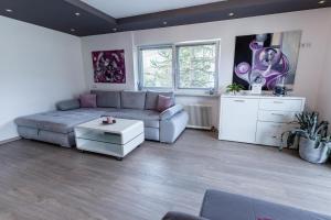 a living room with a couch and a table at Pension Ferienwohnung Pirhofer in Kramsach