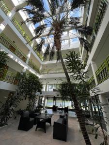 a lobby with a palm tree in a building at Kylpylä-Hotelli 345 in Ikaalinen