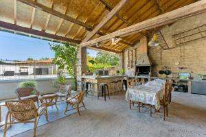 an outdoor kitchen and dining area with a table and chairs at Chambres D'hôtes Le Cocon in Saint-Paul-les-Fonts