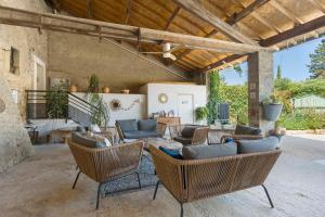 an outdoor living room with couches and chairs at Chambres D'hôtes Le Cocon in Saint-Paul-les-Fonts