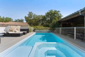 a swimming pool in a yard next to a house at Chambres D'hôtes Le Cocon in Saint-Paul-les-Fonts