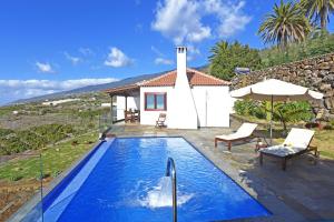 a villa with a swimming pool and a house at Casa Vista Mar in Tijarafe