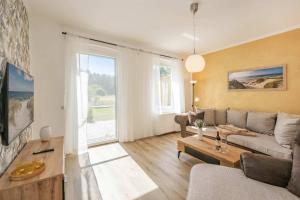 a living room with a couch and a table at Ferienhaus Oscar in Garz