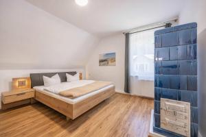 a bedroom with a bed and a large window at Ferienhaus Oscar in Garz