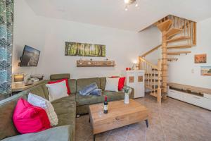 a living room with a couch and a wooden table at Ferienwohnung Emily in Garz