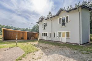a large white house with a garage at Ferienwohnung Emily in Garz