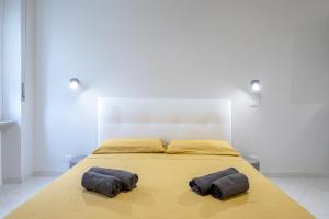 two pillows on a bed in a white room at RELAX APARTMENT in the Mountains in Valdieri