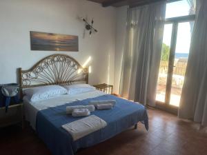 a bedroom with a bed with towels on it at Il Villaggetto sul Mare in Favignana