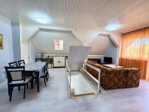 a living room with a table and a couch at Oli vendégház in Balatonboglár