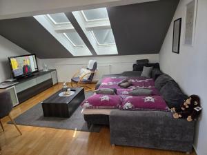 a living room with a couch and a bed at DenVigo in Čakovec +8 photos