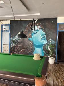 a mural in a room with a pool table at Moonshiva stay and cafe in Rishīkesh +10 photos