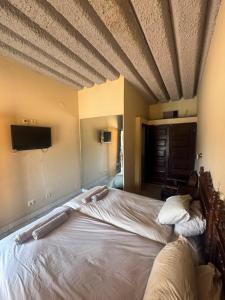 a bedroom with a large bed with a ceiling at Executive Manica Hotel in Chimoio +24 photos