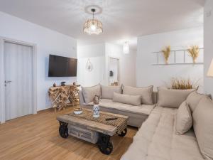 a living room with a couch and a coffee table at Sea Memories Villa in Skaleta