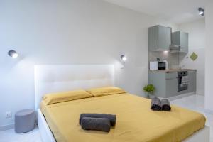 a bedroom with a large bed with two towels on it at RELAX APARTMENT in the Mountains in Valdieri