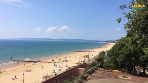 a group of people on a beach near the ocean at Lelola Lodge in Bournemouth