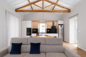 a living room with a couch and a table at Casa da eira in Ribeira Grande