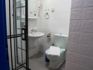 a white bathroom with a toilet and a sink at Karma homes in Turunç +36 photos