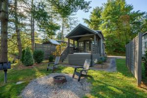 a tiny house in the woods with a fire pit at Asheville River Cabins, WorldHotels Backdrop in Arden