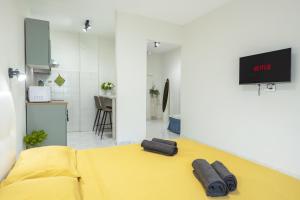 a room with a yellow bed with two pillows on it at RELAX APARTMENT in the Mountains in Valdieri