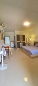 a large bedroom with a bed and a table at Samati Best House - Pool Apartments A1 - Klong Ning Beach in Ko Lanta Yai +34 photos