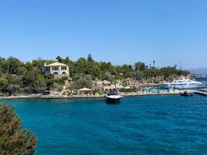 a boat is docked in a large body of water at Villa J&C-SAINT AIMILIANOS in Porto Heli