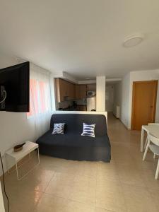 a living room with a blue bed and a kitchen at Ideally Located Holiday Apartment in Moncófar +13 photos