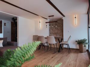 a living room with a dining room table and chairs at Vikendica Family in Gojsalica