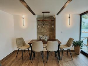 a dining room with a wooden table and chairs at Vikendica Family in Gojsalica +29 photos