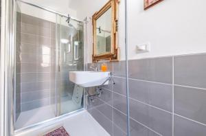 a bathroom with a sink and a shower at Casa Luce in Milazzo