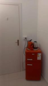 a red cabinet with a tea kettle on top of it at Casa Luce in Milazzo