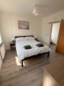 a bedroom with a bed with two towels on it at Clohanbeg School House in Kilrush +5 photos