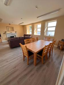 a living room with a wooden table and chairs at Clohanbeg School House in Kilrush
