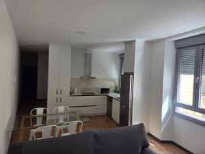 a kitchen and dining room with a table and chairs at Plaza España 2 in Alcazar de San Juan