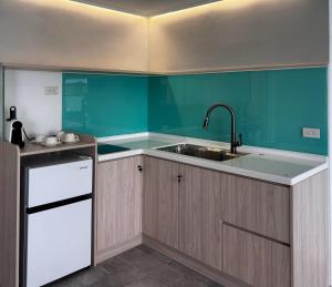 a kitchen with a sink and a green wall at 南灣飯店 Kenting Nanwan Hotel in Nanwan