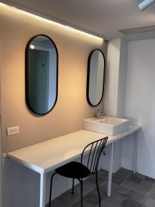 a bathroom with a sink and two mirrors at 南灣飯店 Kenting Nanwan Hotel in Nanwan +218 photos