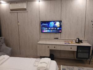 a hotel room with a tv on a wall at Sunset hill in Büyükçekmece +1 photo