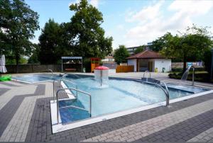 a large swimming pool with a slide in it at Sachsenheim Rooms & Apartments in Sachsenheim