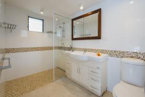 a bathroom with a toilet and a sink and a mirror at Suva Point Ocean Front Nukulau Island Views in Suva +21 photos
