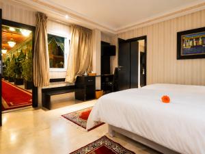 a bedroom with a white bed and a window at Palais Riad Reda & Spa in Fez