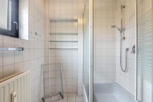 a bathroom with a shower and a bath tub at Erholungspark Wilhelmsruh in Möhnesee +15 photos