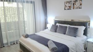 a bedroom with a large bed with white sheets and pillows at Rima Salalah in Salalah +27 photos