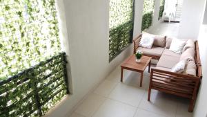 a living room with a couch and a table on a balcony at Rima Salalah in Salalah